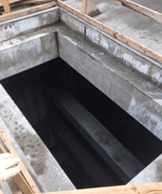 Manway entry into a below-grade storm water detention tank
