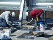 Reinforcing fabric installation on a roof top